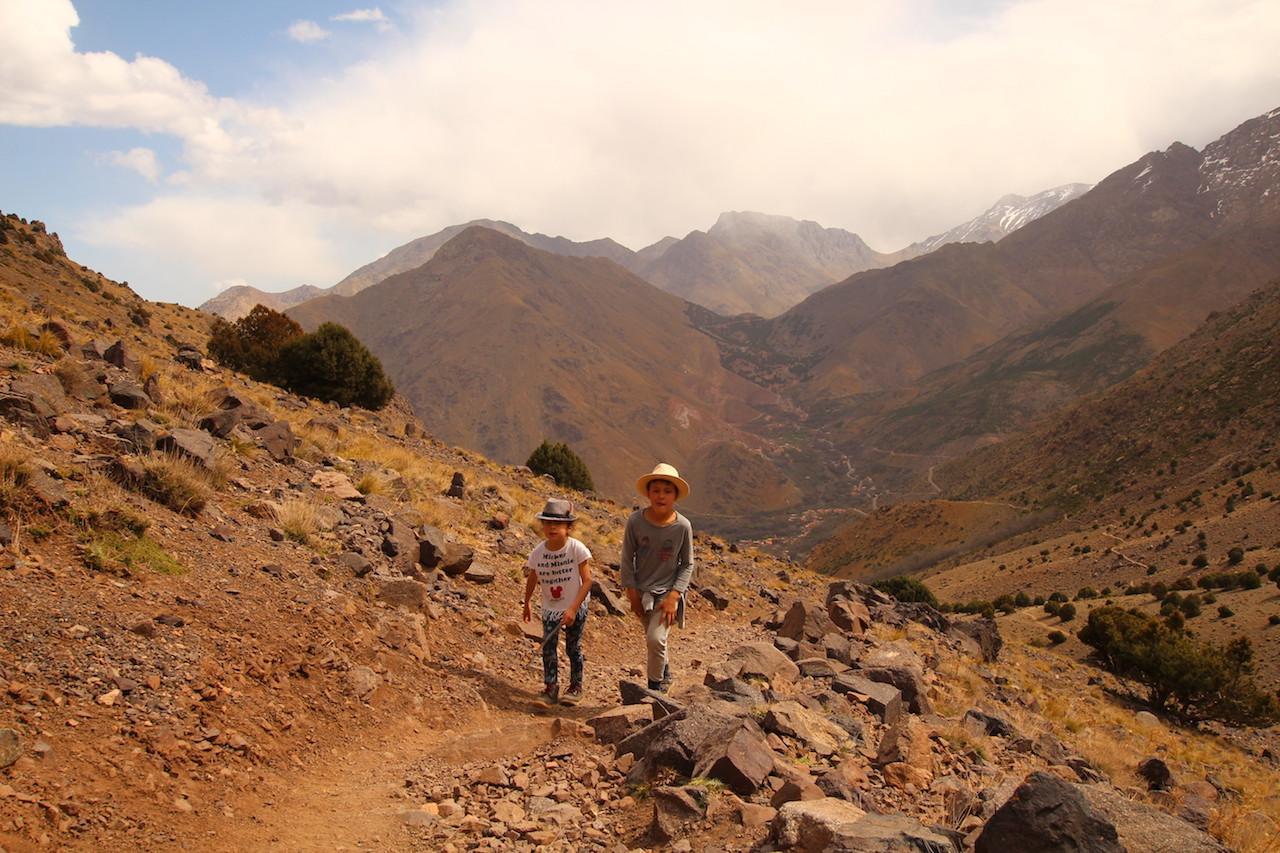 children trekking next to Imlil