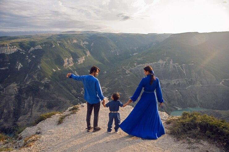 Family of three holding hands and admiring a breathtaking mountainous landscape, representing the unforgettable and family-friendly adventures crafted by the best Morocco tour companies for nature lovers and explorers Family of three holding hands and admiring a breathtaking mountainous landscape, representing the unforgettable and family-friendly adventures crafted by the best Morocco tour companies for nature lovers and explorers