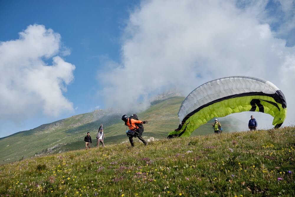 Paraglider launching from a mountain slope during a paragliding flight in Morocco
