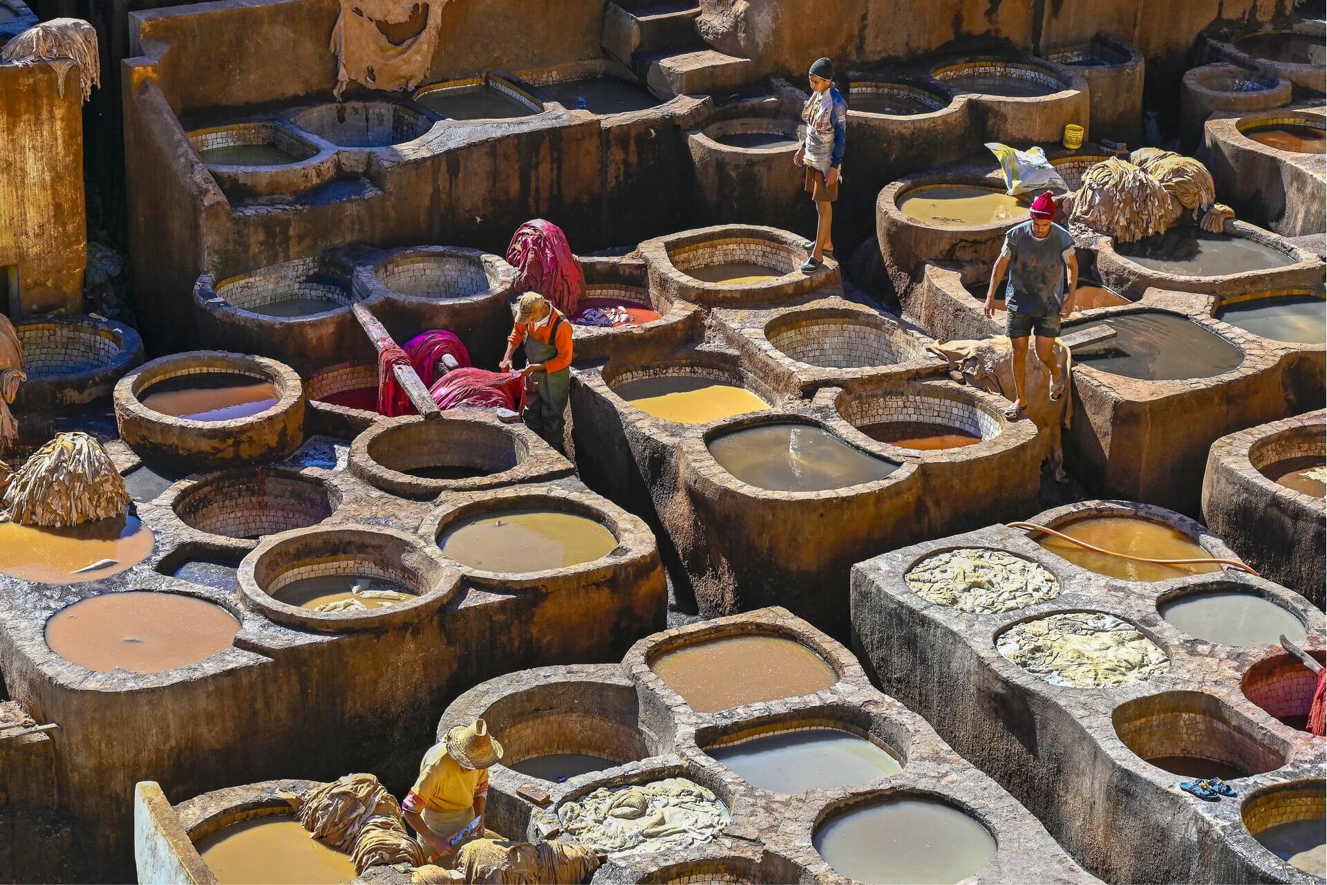 Visit Morocco: A Luxury Journey Through Imperial Cities, Atlas Peaks and Sahara Dunes 11 Workers hand-dyeing leather in the centuries-old Chouara tannery vats in Fes, one of Morocco's most iconic cultural sights