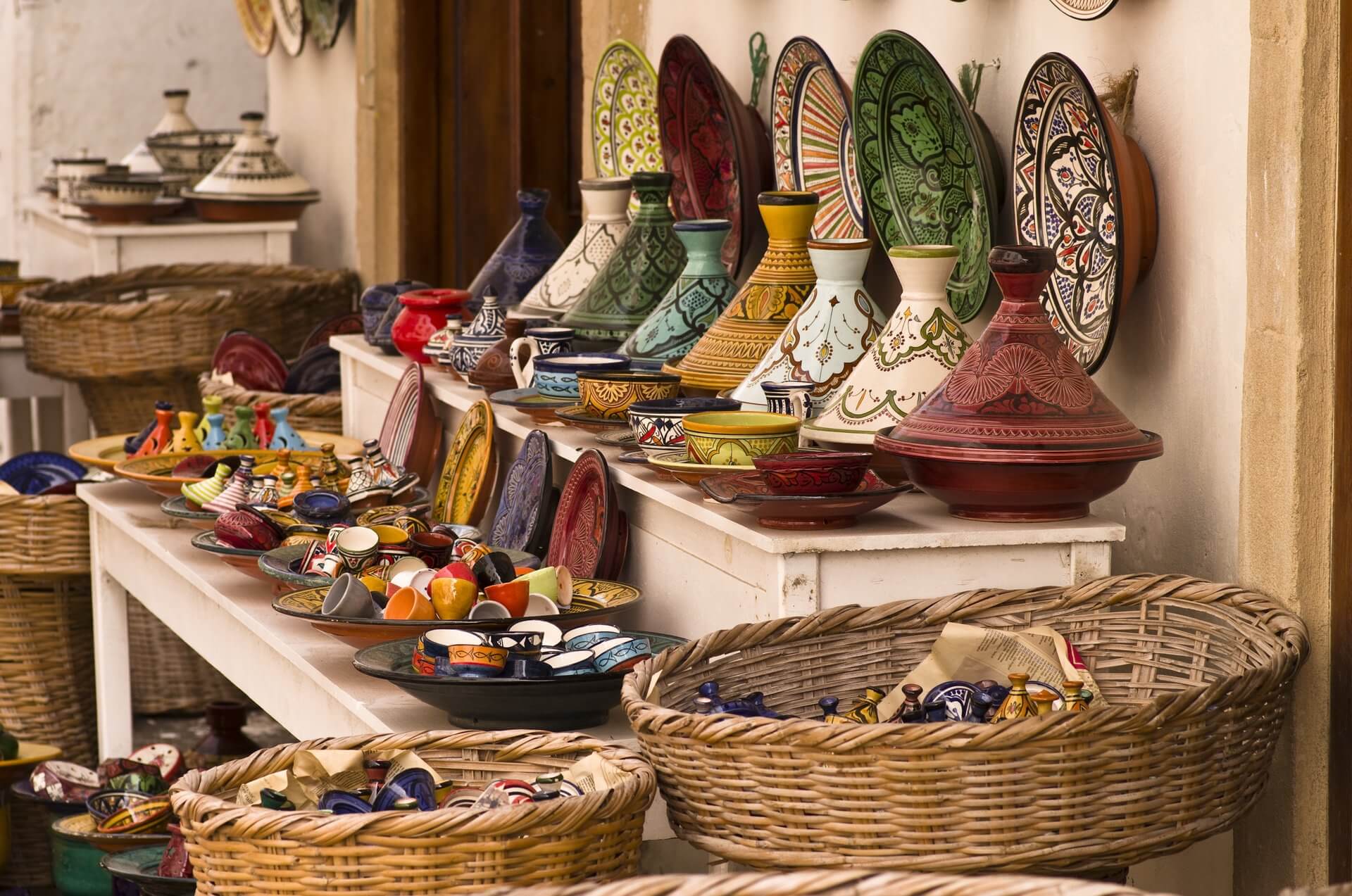 Best Time to Visit Morocco: A Seasonal Guide for the Discerning Traveler 11 Traditional Moroccan ceramic pottery and tajine dishes displayed in a medina shop, a cultural highlight for visitors to Morocco